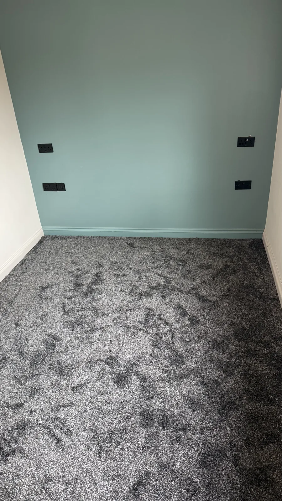 Patterned grey carpet fitted in an empty room