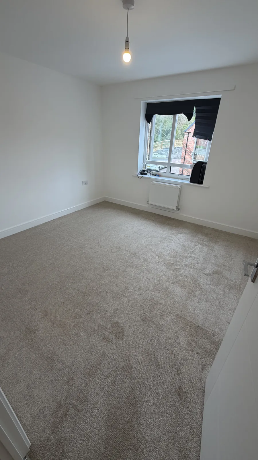 Light grey carpet fitted in an empty room