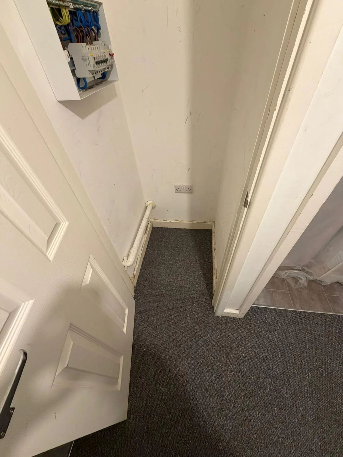 Dark carpet fitted through adjoining doorways