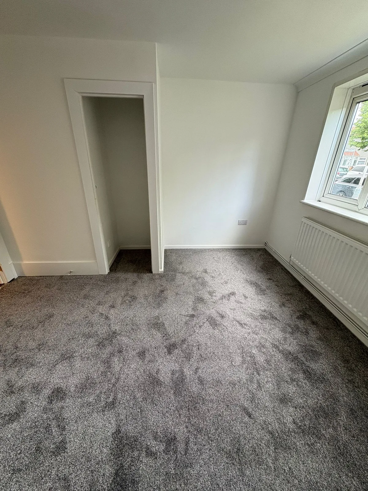 Grey patterned carpet fitted in a bright room