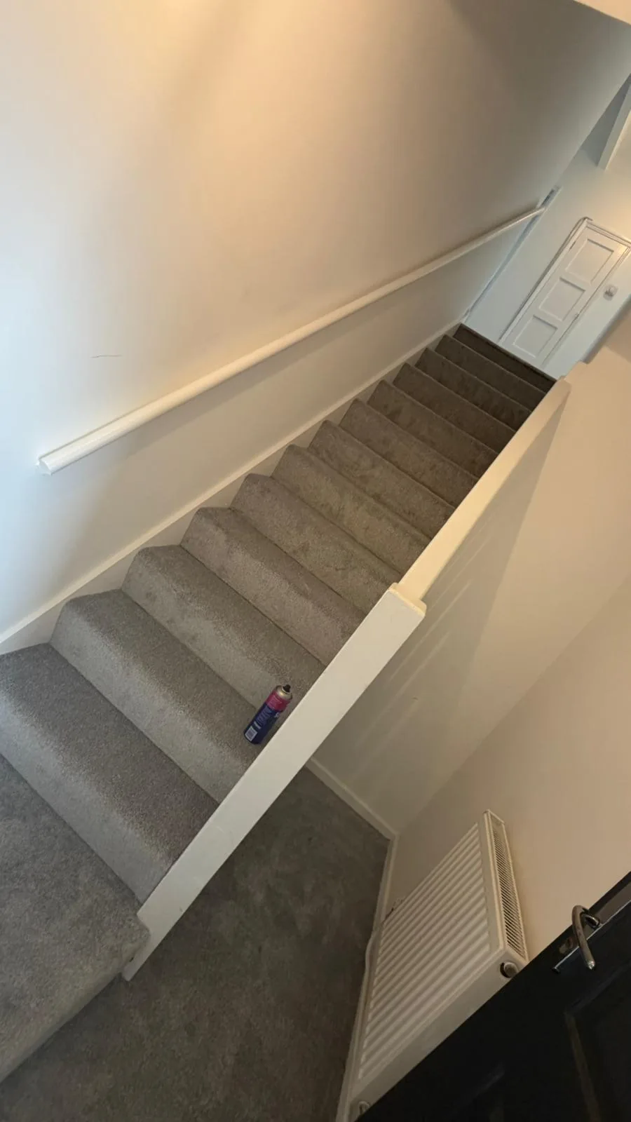 Striped carpet fitted on steps beside a landing