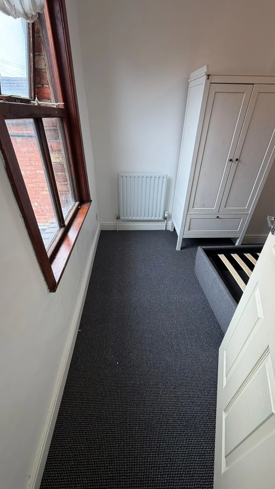 Dark carpet fitted across a landing and doorway