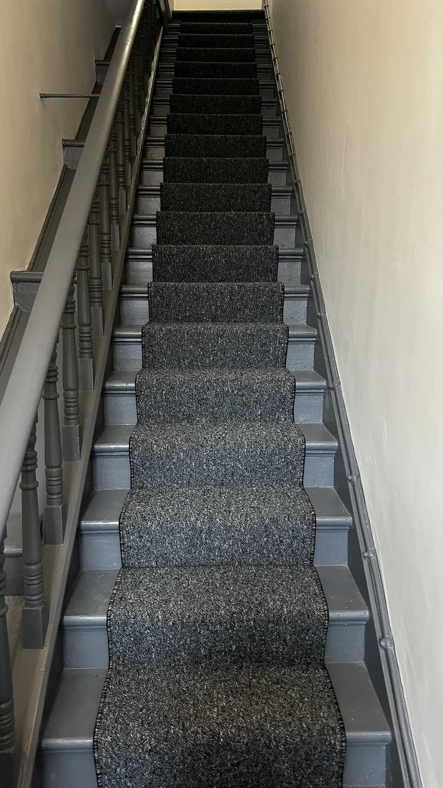 Dark striped runner fitted on a staircase