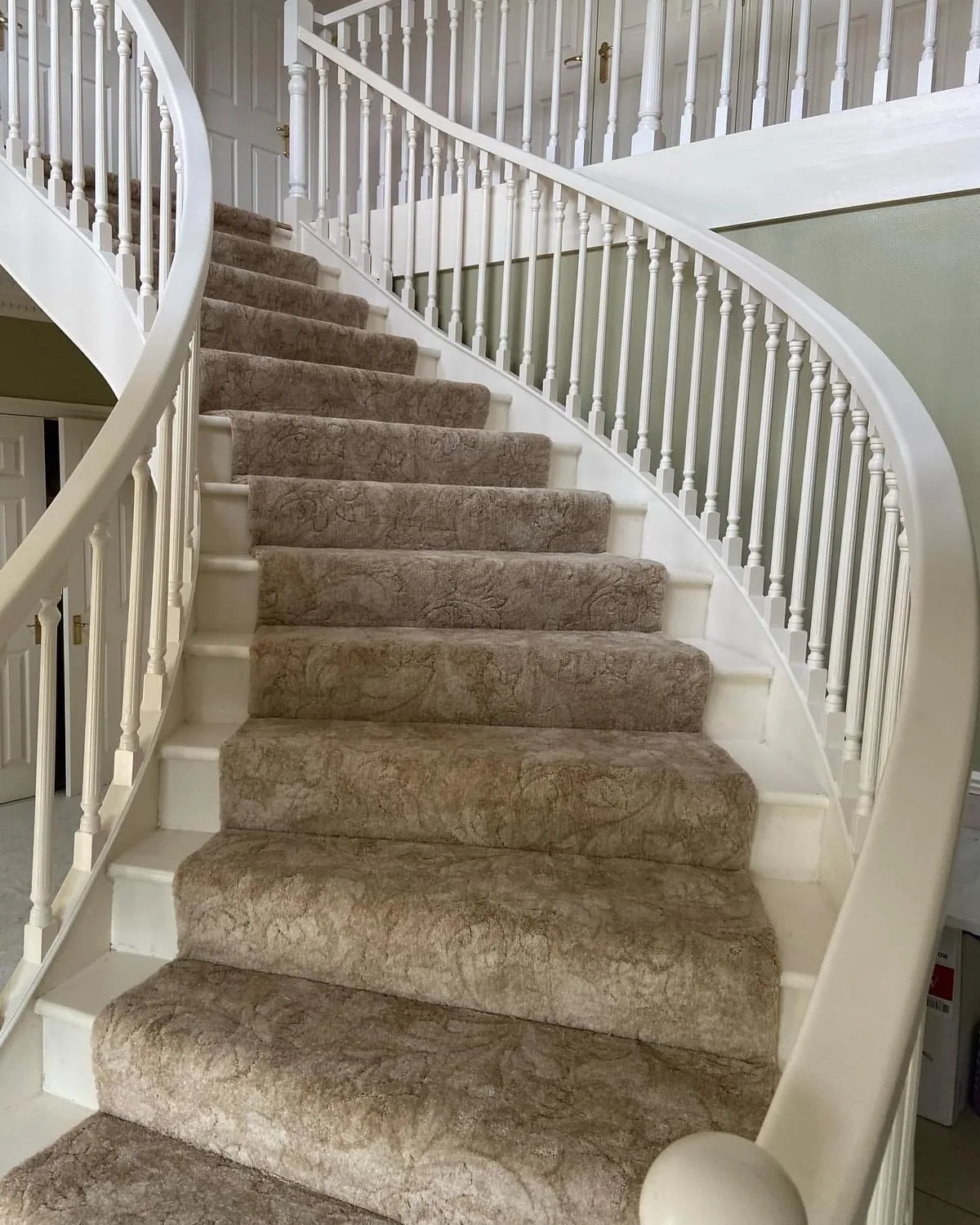 Beige carpet fitted on a curved staircase