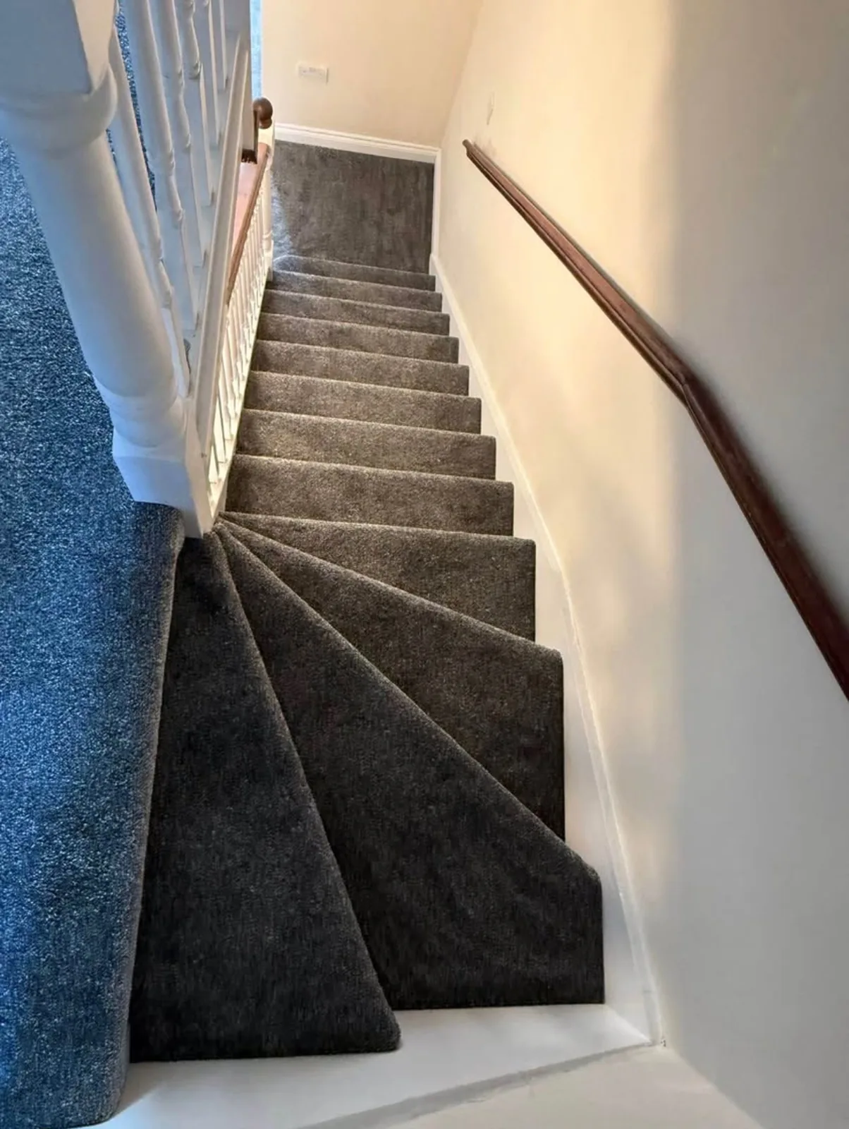 Dark striped carpet runner fitted on stairs