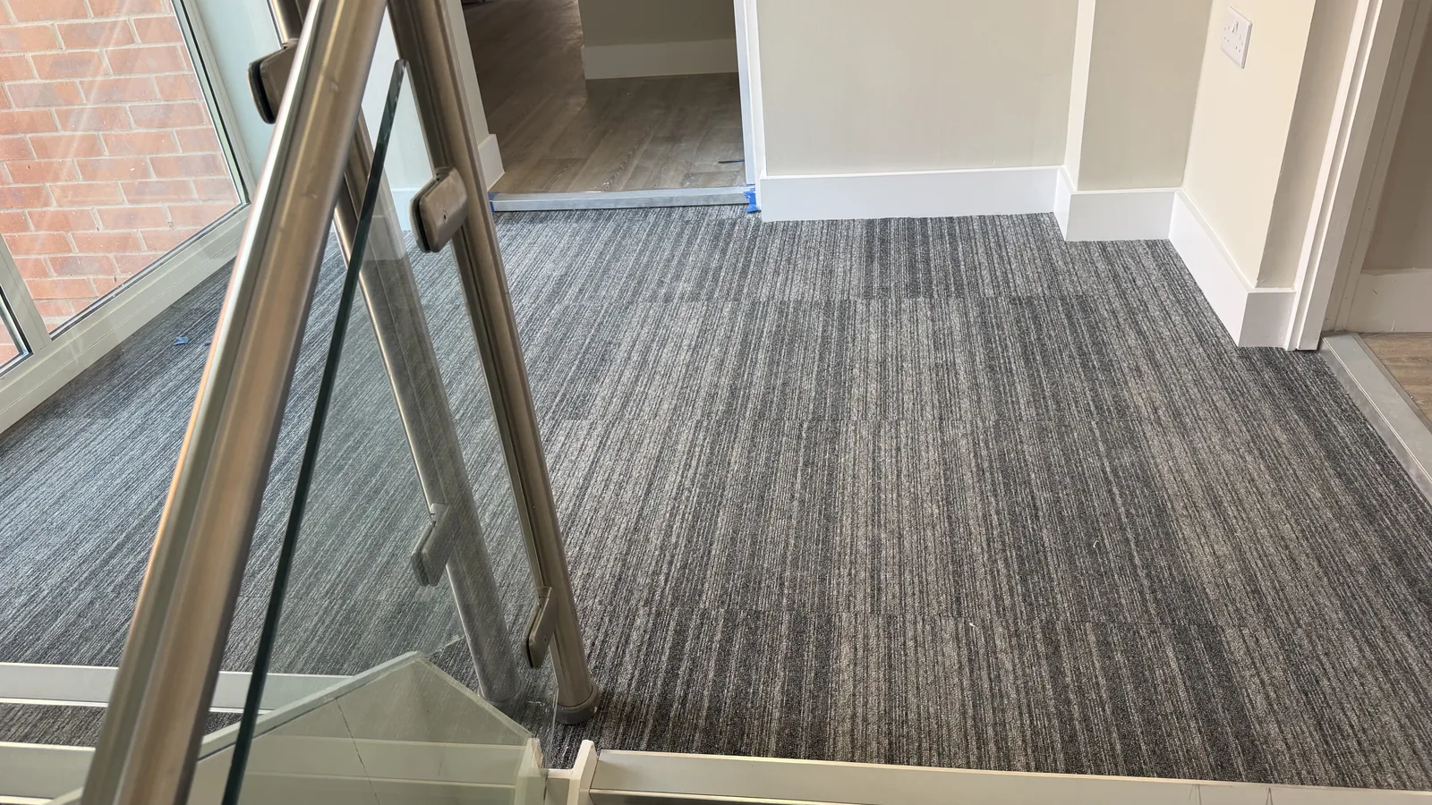 Striped carpet fitted across a wide staircase