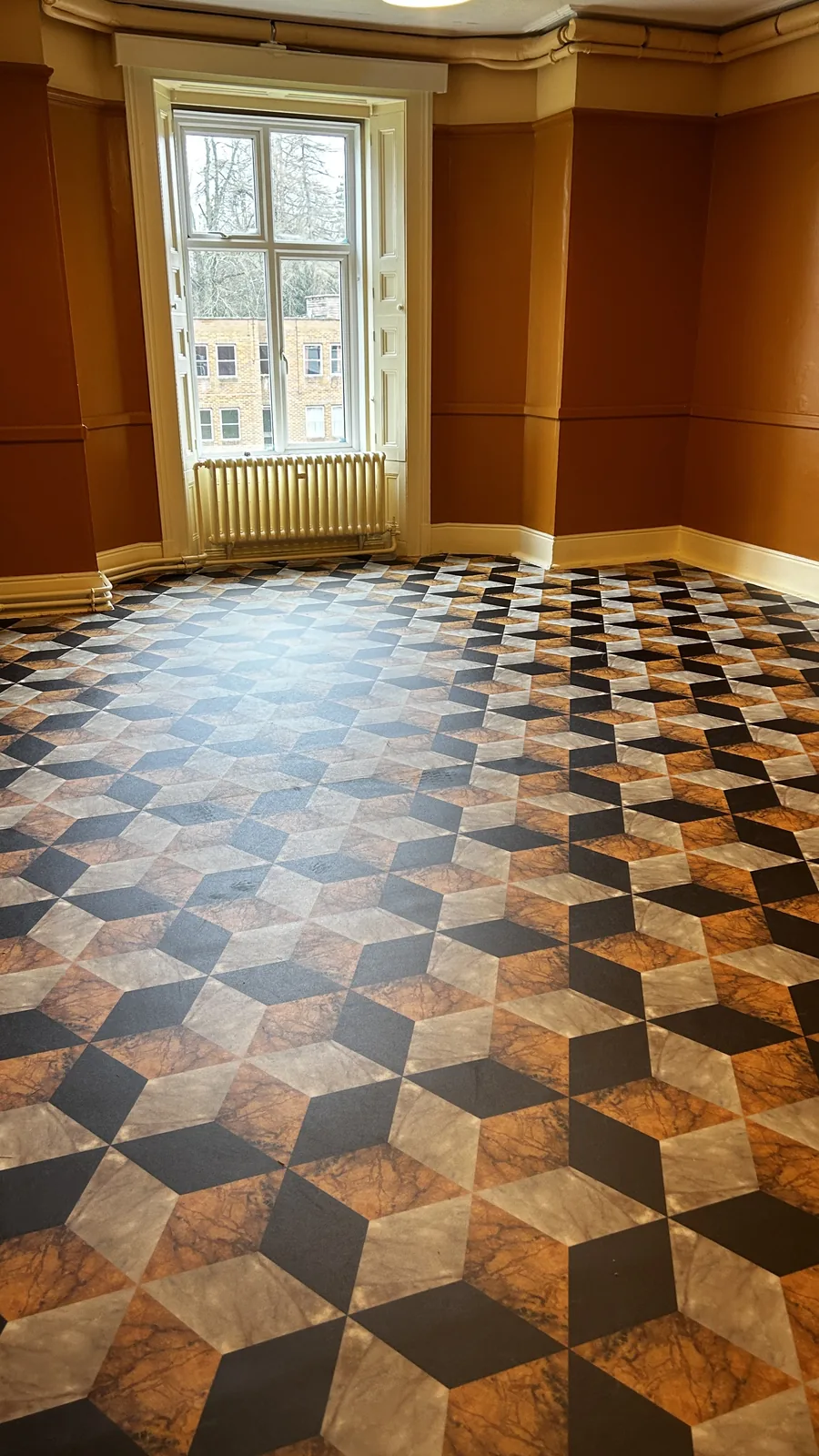 Geometric patterned vinyl flooring in an empty room