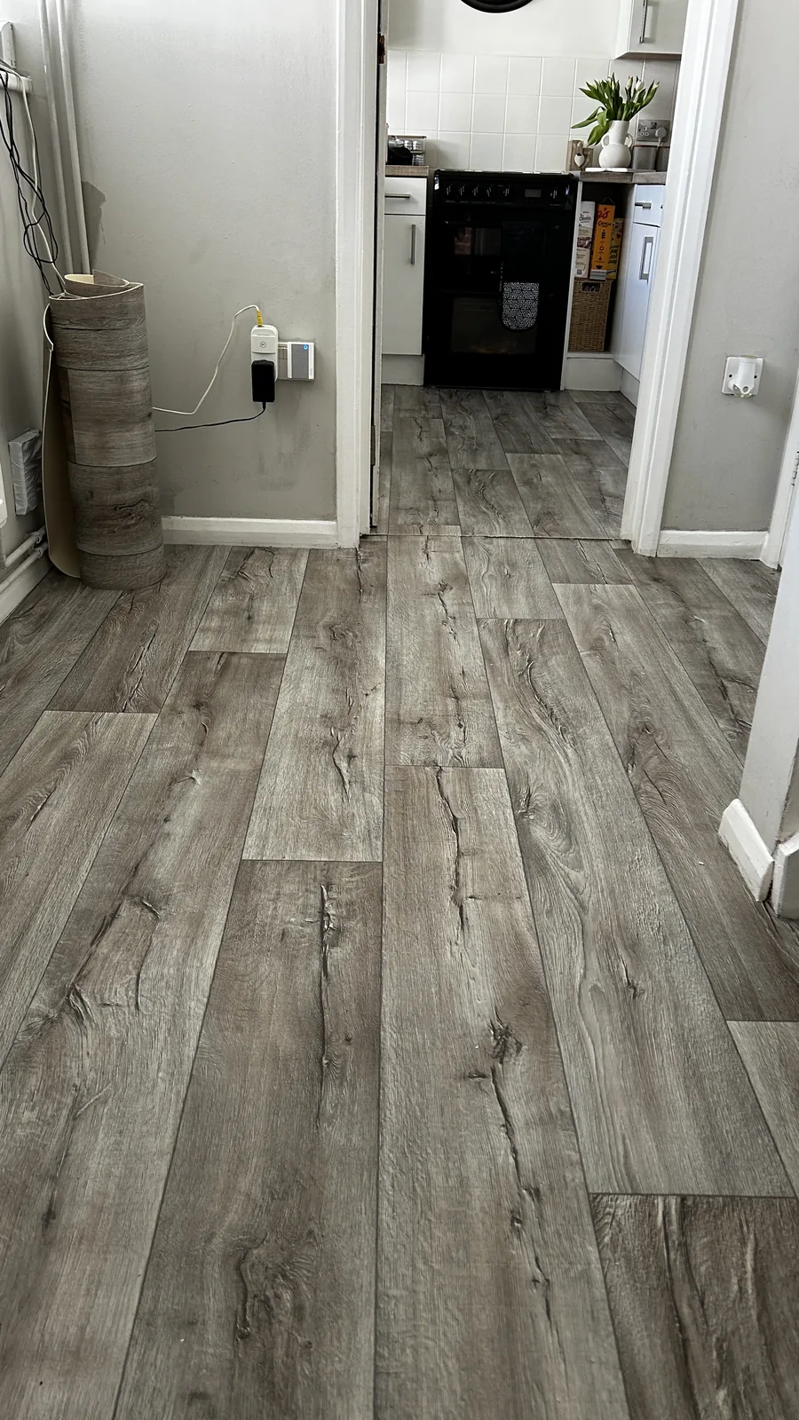 Grey wood-effect vinyl flooring through a hallway