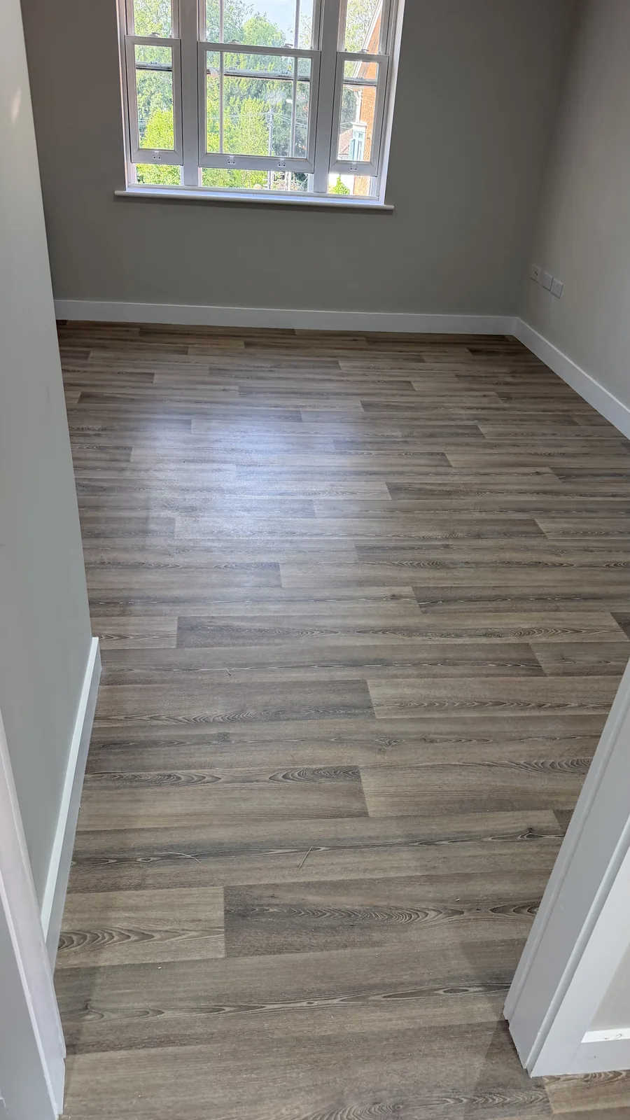 Wood-effect vinyl flooring in an empty room