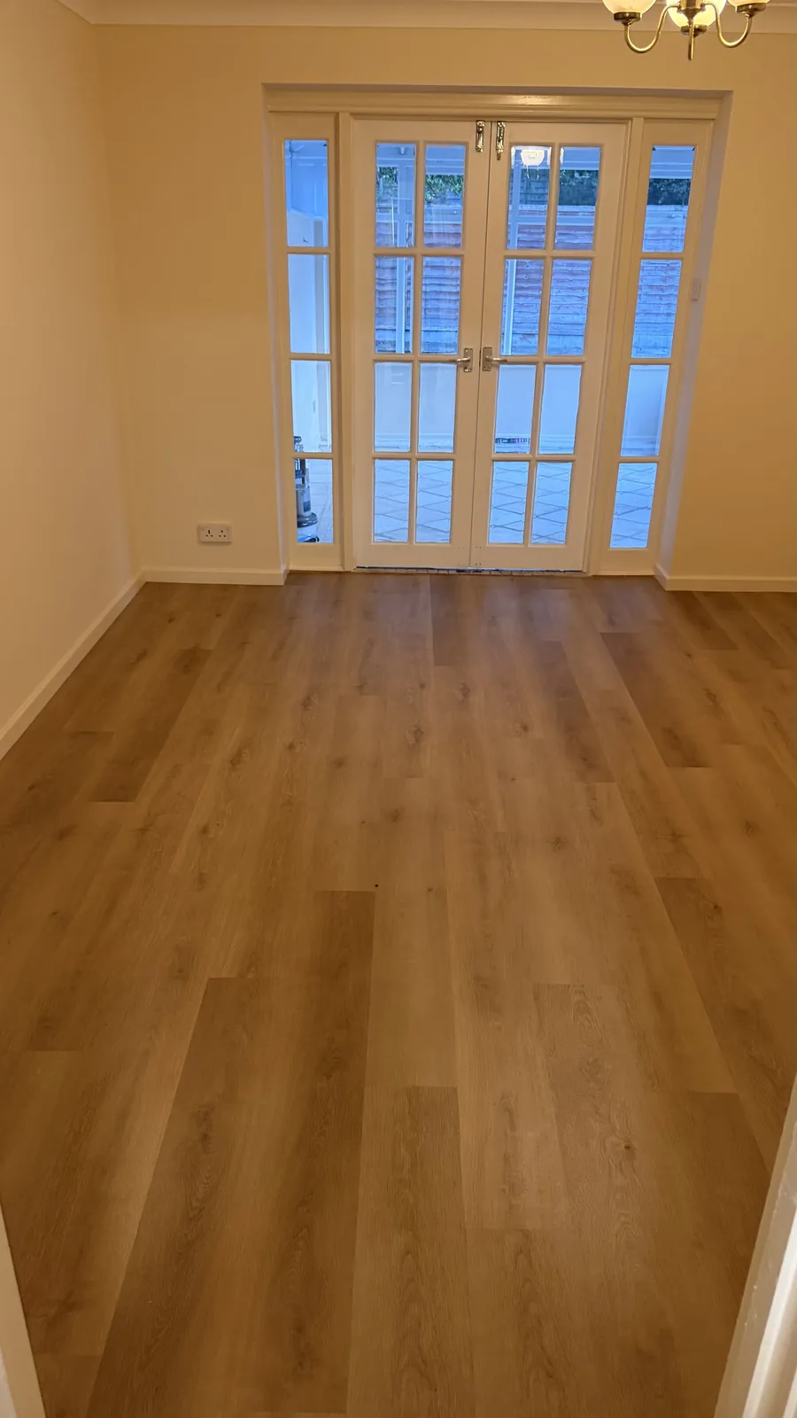 Warm wood-effect LVT fitted through a bright room