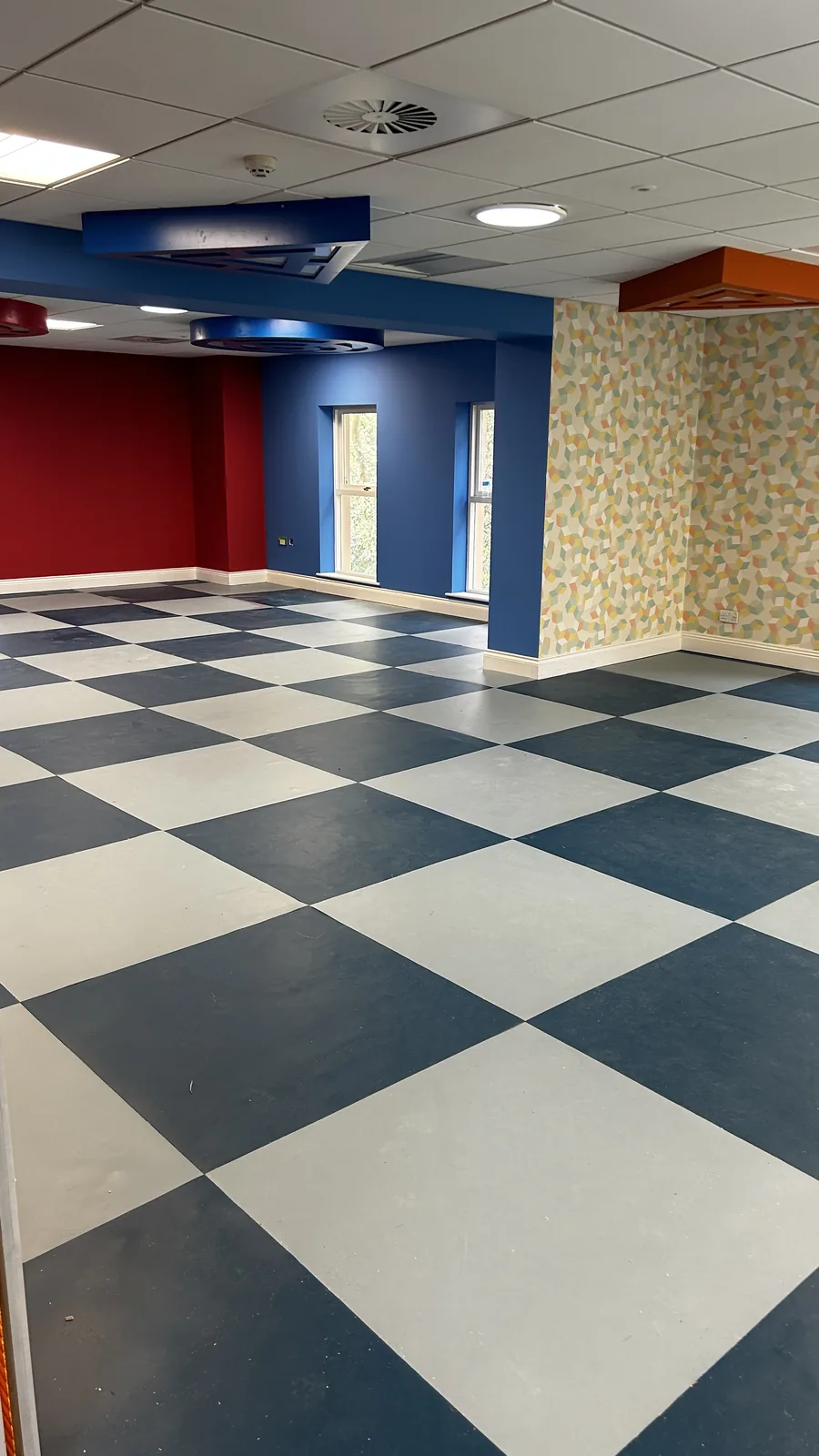 Black and white chequered safety flooring in a large interior
